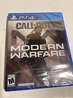 Front photo of factory sealed PS4 Call of Duty Modern Warfare game case with cover art showing a soldier.