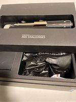 Star Wars Jedi Challenges box with chrome lightsaber hilt visible inside.