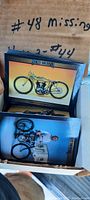 Photo showing a box with a thick stack of Harley Davidson trading cards, card images visible with motorcycles, card #48 marked missing