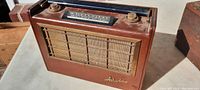 Front view of antique Arvin portable radio with fabric speaker grille and Arvin logo