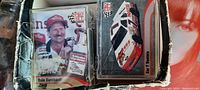 Close-up photo showing Dale Earnhardt racing card and racing car card in a box, with visible wear on box edges.