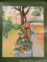 Photo showing canvas print with a colorful flower bed arrangement along a pathway under a tree.