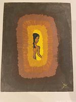 Frontal photo of unsigned canvas print featuring stylized nude figure with yellow, brown, and orange concentric background, signed by artist in lower right corner.