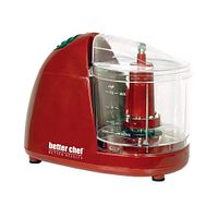 Side view image of the red Better Chef Compact Chopper showcasing its compact size and clear bowl with the blade inside.