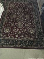 Full view of the rug showing the overall floral medallion pattern and border design.