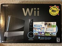 Front of black Wii console box showing Wii branding and included games
