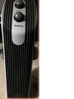 Front view of Holmes mini tower air purifier showing vertical stripes and two control knobs on top front