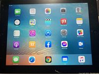 Apple iPad 3rd Generation powered on, home screen with standard apps.