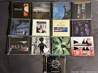 Top view of multiple Depeche Mode albums, showing a variety of their releases in jewel cases arranged in rows.