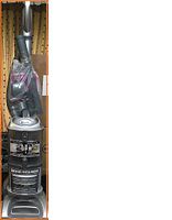 Full upright view of Shark UV440 vacuum showing dust bin and handle wrapped in plastic.