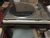 Front view of the Technics SL-Q2002 with dust cover closed showing the turntable and brand markings.