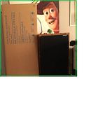 Photo showing two boxed Christopher Lowell Lattix stackable bookcases along with a Woody Toy Story figure poster in the background.