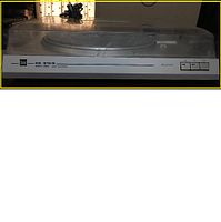 Front view of Dual CS-616Q Quartz Direct Drive Semi-Automatic Turntable with dust cover closed, showing the controls and model label.