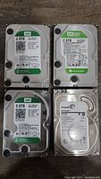 Photo showing all four SATA hard drives; three Western Digital Green 2TB drives and one Seagate Barracuda 2TB drive.