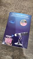 Box of Koolertron Wi-Fi Digital Microscope showing product image and features.