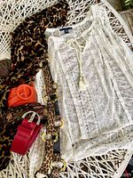 Photo showing all items including the American Eagle white lace top, leopard print scarf, red leather belt, vintage leopard sash belt, vintage orange belt, and beaded sequin belt.