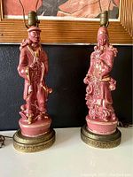 Front view of the pair of pink rose ceramic vintage Mid Century Asian Empress and Emperor lamps with gold accents and brass bases.