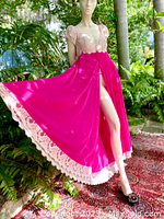 Mannequin modeling the magenta nightgown with ivory lace bodice and hemline lace trim, outdoors with foliage background
