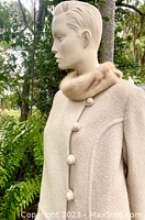 Close-up of the blonde mink fur collar, oatmeal woven wool fabric, and self-covered buttons.