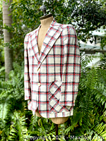 Side angle profile of the plaid jacket showing button details and texture