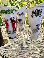 Close-up of two pilsner glasses showing Good Old Days and Curio Carriage Collection artwork