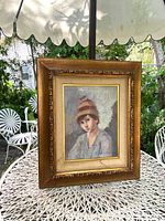 Front view of the framed oil painting showing the full artwork and frame including the ornate wooden border and visible staining on the matting.