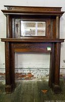 Full frontal view of oak mantel shelf with mirror