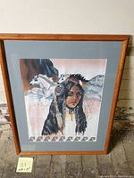 Full image of the framed needlepoint art featuring the Native American woman and horses.