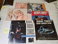 Image showing two packs of Batman Returns movie cards, Star Trek The Next Generation and Deep Space Nine calendars, Olivia pinup calendars.