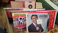 Photo showing a collection of vinyl record albums in sleeves with visible titles including Jerry Vale, Polish House, Jimmy Swaggart, Christmas albums, and others.