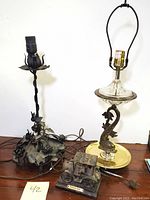 Photo showing entire lot with both lamps and model car on wooden surface against white background.
