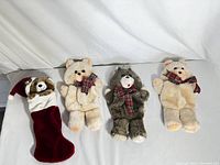 Front view of the 3 teddy bear stockings and bonus Christmas stocking featuring bears with plaid scarves and Santa hat.