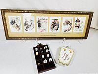 Wide view showing entire framed pictograph depicting marriage stages, wooden thimble shelf with thimbles, and embroidered cloth piece.