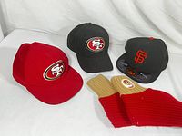 Lot of 3 youth hats with San Francisco 49ers logos and sized San Francisco Giants fitted hat, plus pairs of 49ers socks.