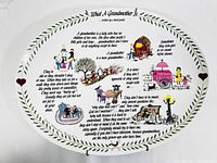 Front view of the ceramic platter showing the full poem titled 'What A Grandmother Is' with accompanying colorful illustrations and green leaf border.