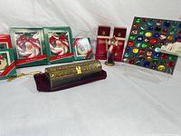 Wide shot showing decorative wooden box with brass overlay, Santa Claus ornament boxes, Christmas Memories boxes, nutcracker figurine, and colorful glass gem display board