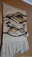 Full view of the woven wall hanging showing design and size