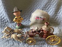 Firefighter statue, baseball cap with fire truck embroidery, and Franklin Mint fire engine model pulled by horses