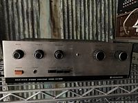 Front view of Kenwood stereo amplifier showing bass, treble, balance controls and power switch with model number KA-2002.