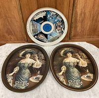 Photo showing all three trays: one Expo Canada round tray and two Pepsi Cola oval trays with a woman in a blue dress design.