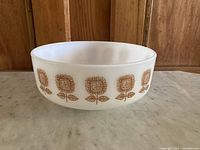 Front side view showing the sunflower flower pattern repeated around the bowl