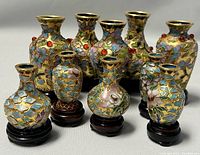 Front view of the ten Chinese miniature cloisonné vases arranged in rows with clear detail of colors, patterns, and wood bases