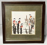 Framed brush watercolor painting showing stylized birds and Chinese signature with red seal.