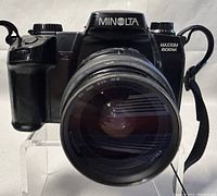Front view of Minolta Maxxum 600si camera with lens attached.