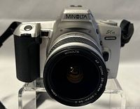 Front view of Minolta STSi 35mm camera with attached AF Zoom 28-80mm lens showing clear lens info and camera model.