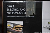 Close-up of box label showing '3 in 1 Electric Raclette and Fondue Set' text indicating the product type and suitability for up to 8 people