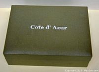 Closed green textured box with Cote d' Azur logo on top