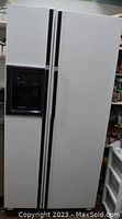 Full front view of white GE side-by-side refrigerator