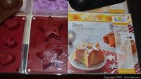 Contents showing red star-shaped and gingerbread man-shaped silicone baking pans and packaging for star shape baking pan