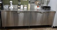 Front view of entire stainless steel cabinet with countertop and four doors